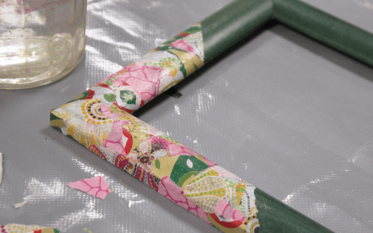 Photographie d’un cadre qui a été customisé et upcyclé avec des papiers de couleur et à motif. Création réalisée lors de l'atelier décoration de cadres.